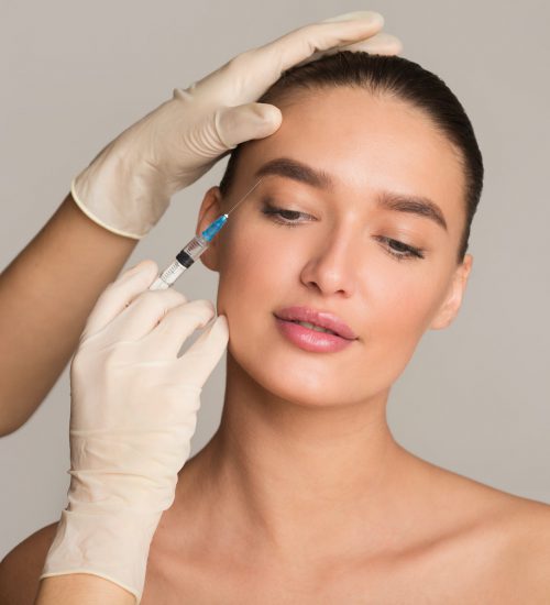 Woman with perfect skin receiving botox injection